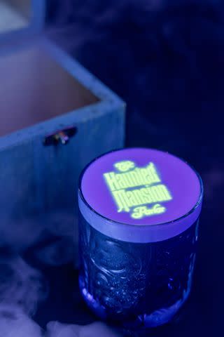 <p>Courtesy Disney</p> Tequila-based cocktail featuring a black light message offered at the Haunted Mansion parlor.