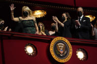 First lady Jill Biden waves as she arrives at the 44th Kennedy Center Honors at the John F. Kennedy Center for the Performing Arts in Washington, Sunday, Dec. 5, 2021. Vice President Kamala Harris and second gentleman Doug Emhoff applaud at right. The 2021 Kennedy Center honorees include Motown Records creator Berry Gordy, "Saturday Night Live" mastermind Lorne Michaels, actress-singer Bette Midler, opera singer Justino Diaz and folk music legend Joni Mitchell. (AP Photo/Carolyn Kaster)