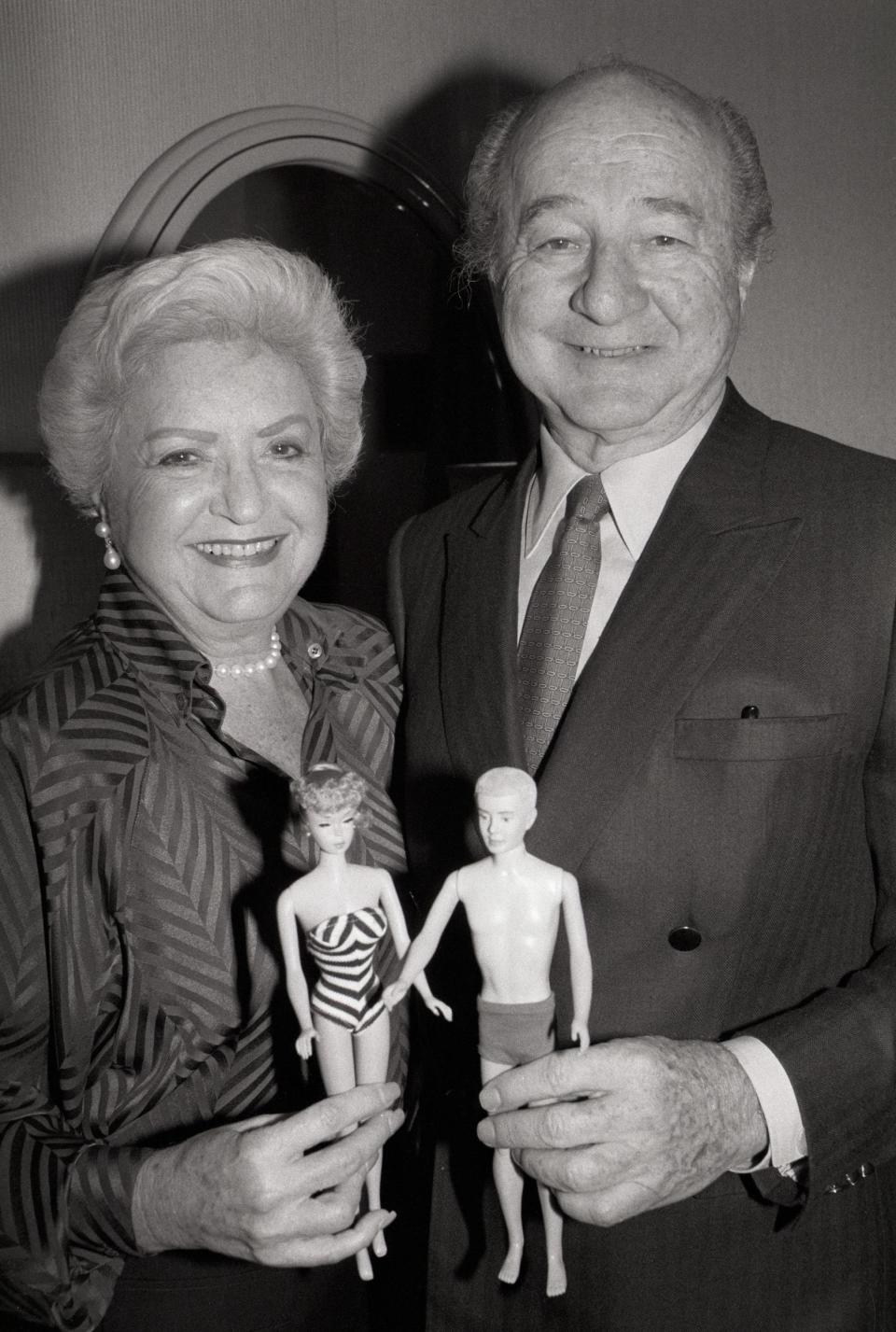 Ruth and Elliot Handler holding Barbie dolls in 1987.