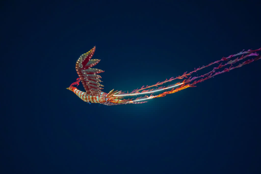 Tourists watched a remote-controlled performance of a flying phoenix during an early Lantern Festival celebration in Chongqing, China, on Feb. 23, 2024. <span class="copyright">Future Publishing—Getty Images</span>
