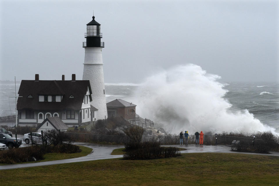 A wave slams into the rocks at Portland Head Light, Maine, during a powerful winter storm, Friday, Dec. 23, 2022, in Cape Elizabeth, Maine. (AP Photo/Robert F. Bukaty)