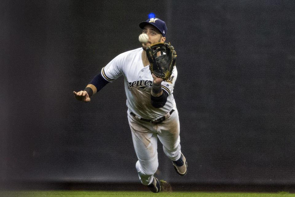 FILE - In this April 22, 2017, file photo, Milwaukee Brewers' Ryan Braun makes a diving catch on St. Louis Cardinals' Kolten Wong's fly ball but made a throwing error allowing a run to score during the fourth inning of a baseball game in Milwaukee. Braun, the Brewers' home run leader whose production was slowed by injuries during the second half of his 14-year career, announced his retirement on Tuesday, Sept. 14, 2021. Braun hasn’t played all season and said during spring training that he was leaning toward retirement. (AP Photo/Tom Lynn, File)