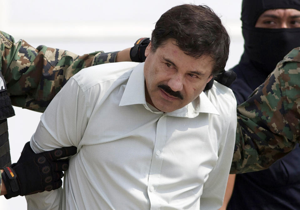 FILE - This Feb. 22, 2014 file photo shows Joaquin "El Chapo" Guzman, the head of Mexico's Sinaloa Cartel, being escorted to a helicopter in Mexico City following his capture in the beach resort town of Mazatlan. Guzman's mother Consuelo Loera died on Sunday, Dec. 10, 2023, according to local media and confirmed by Mexican President Andrés Manuel López Obrador. (AP Photo/Eduardo Verdugo, File)