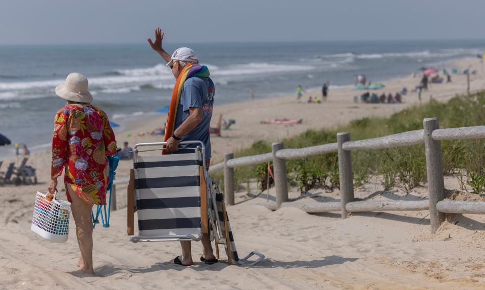 Beach goers wave to friends as they arrive at the beach in Harvey Cedars. Nearly a hald dozen people drowned or died in boating accidents over the 2023 Labor Day holiday weekend.