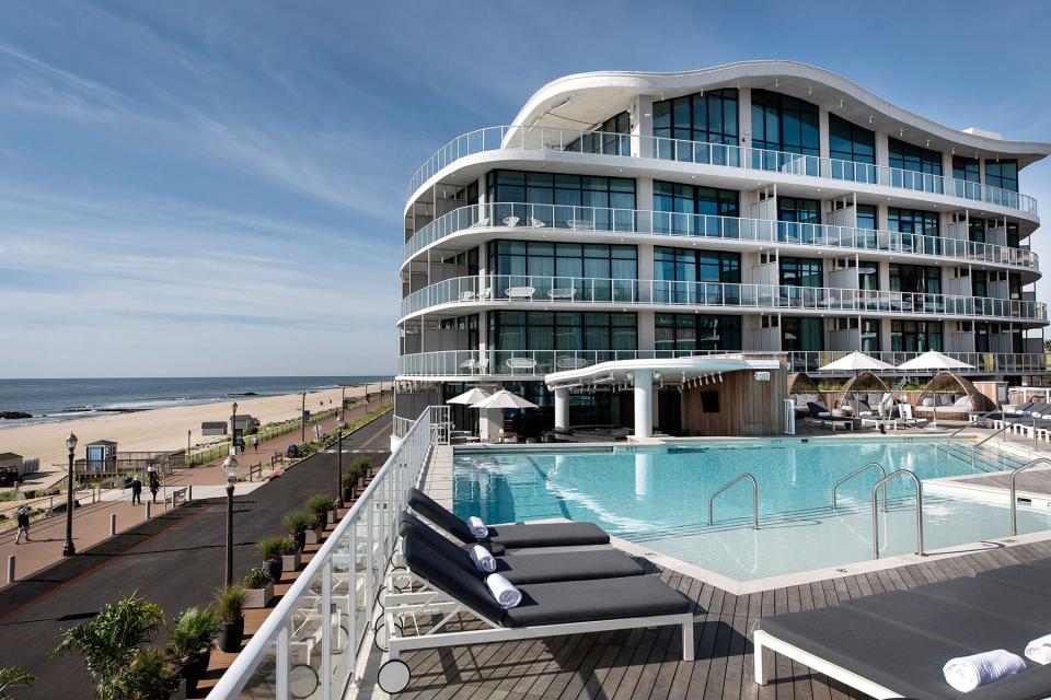 Exterior facade and outdoor pool at Wave Resort over the beach