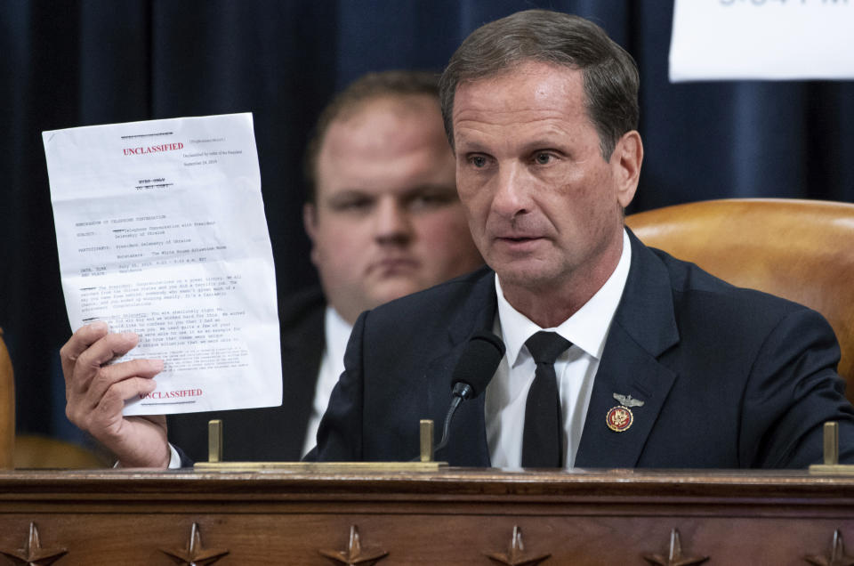 Rep. Chris Stewart, R-Utah, holds up a copy of the transcript of a phone call between President Donald Trump and Ukrainian President Volodymyr Zelenskiy during the House Intelligence Committee on Capitol Hill in Washington, Wednesday, Nov. 13, 2019, in the first public impeachment hearing of President Donald Trump's efforts to tie U.S. aid for Ukraine to investigations of his political opponents. (Saul Loeb/Pool Photo via AP)