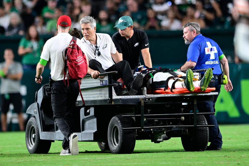Eagles wide receiver Tyrie Cleveland was placed on a backboard and carted off the field after suffering a neck injury.