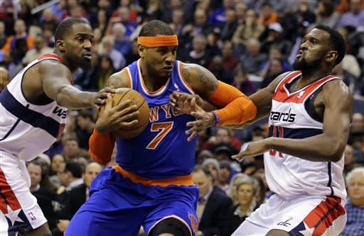 New York Knicks forward Carmelo Anthony (7) drives between Washington Wizards forwards Martell Webster (9) and Chris Singleton (31) in the first half of an NBA basketball game, Friday, March 1, 2013, in Washington. (AP Photo/Alex Brandon)