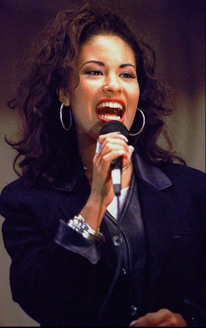 Selena sings at the Cunningham Elementary School in Corpus Christi, Texas, in this Nov. 14, 1994 file photo. The rising Tejano music star was shot dead at 23 by the president of her fan club on March 31, 1995.
