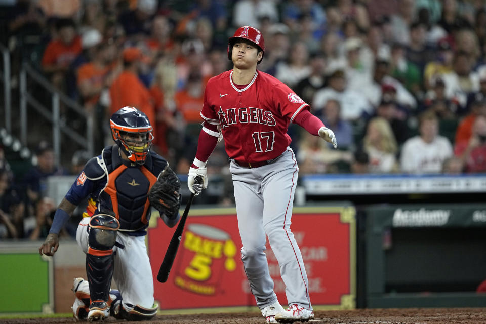 Los Angeles Angels' Shohei Ohtani (17) strikes out swinging as Houston Astros catcher Martin Maldonado holds the ball during the fifth inning of a baseball game Sunday, July 3, 2022, in Houston. (AP Photo/David J. Phillip)