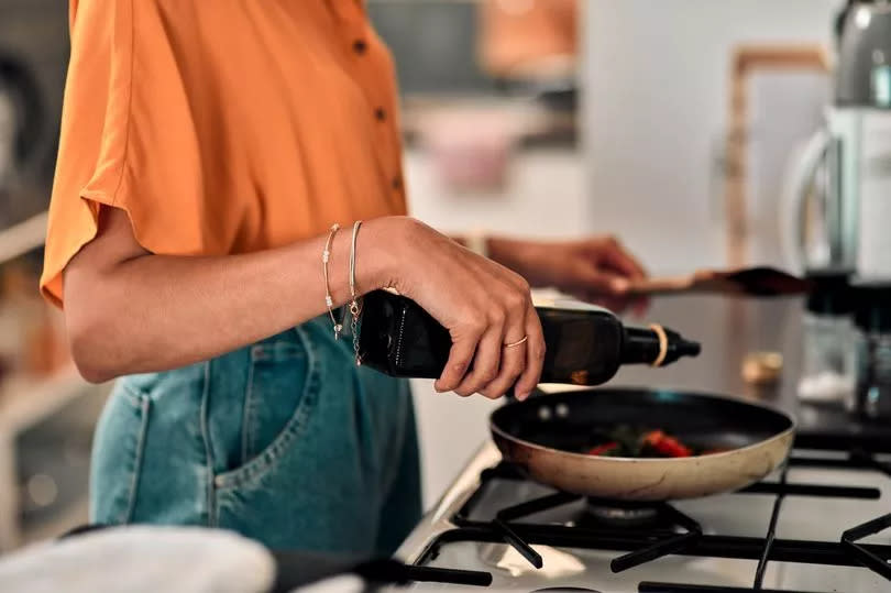 Cropped shot of a young woman preparing a healthy meal at home