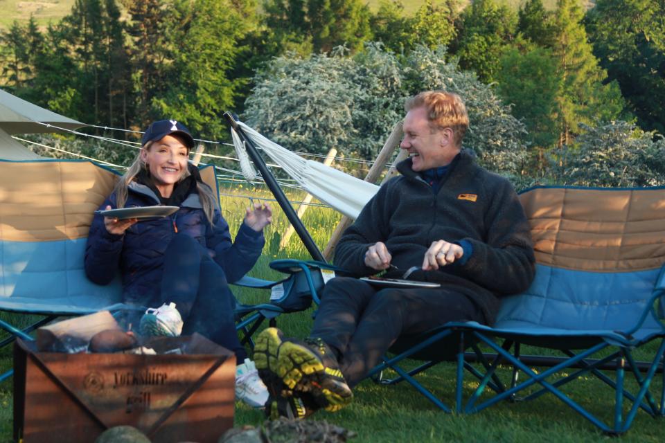 Boh are sitting a their tent site enjoying Goerges pork chops. Having bought them locally. Dan & Helen's Pennine Adventure (Channel 5)