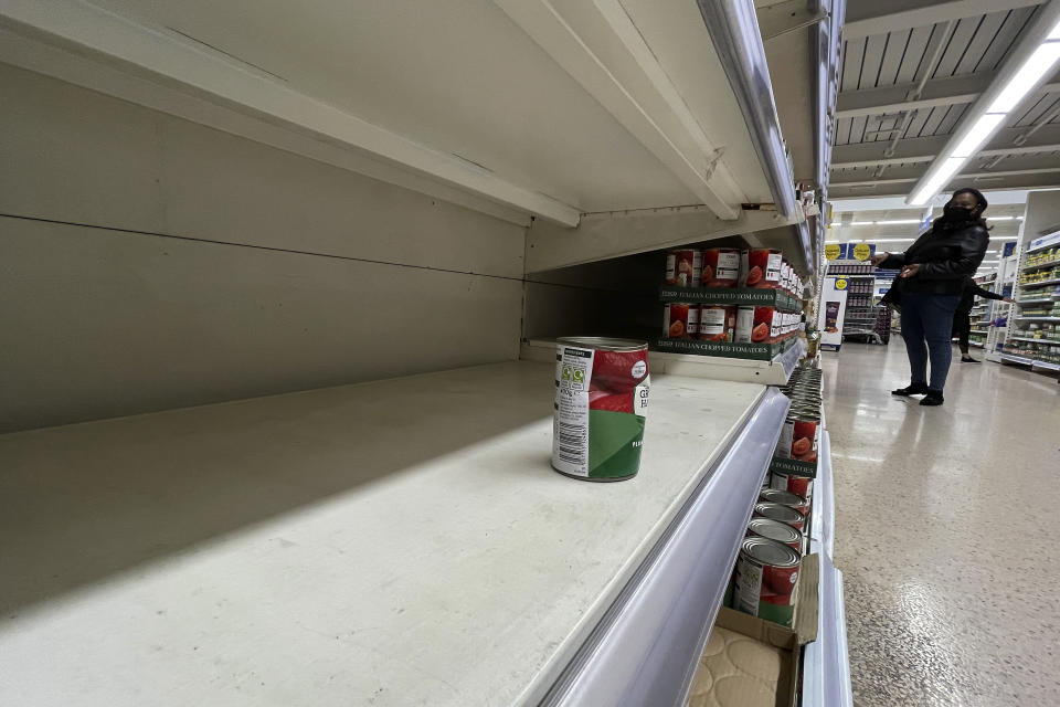 A tin of tomatoes on a shelf at a supermarket in London, Monday, Sept. 20, 2021. Retailers, manufacturers and food suppliers have reported disruptions due to a shortage of truck drivers linked to the pandemic and Britain's departure from the European Union, which has made it harder for many Europeans to work in the U.K. (AP Photo/Frank Augstein)