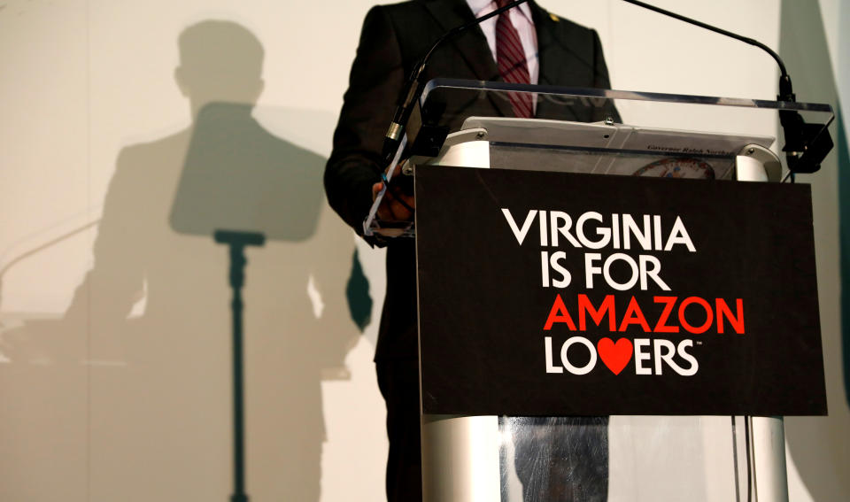 Behind a “Virginia is for Amazon Lovers” sign, Gov. Ralph Northam speaks at a news conference after Amazon announced Crystal City would be one of its new campuses, Nov.13, 2018. (Photo: Kevin Lamarque/Reuters)