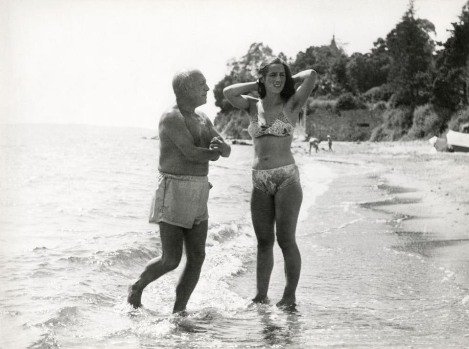 <p>Pablo Picasso and Fracoise Gilot put their feet in the water, circa 1950.</p>