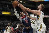 Washington Wizards center Daniel Gafford (21) pulls in a rebound in front of Indiana Pacers forward Domantas Sabonis (11) during the first half of an NBA basketball game in Indianapolis, Monday, Dec. 6, 2021. (AP Photo/AJ Mast)