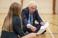 Prime Minister Boris Johnson in the gym taking part in a getting to know you induction session with year sevens as he tours Castle Rock school, Coalville, in the east Midlands.