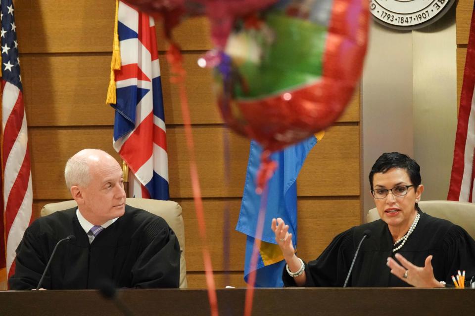 (left to right)Judges Paul Wallace and Vivian Medinilla oversee the adoption ceremony of 6-month-old Sydney making her Dr. Erin Meyer and her wife Dr. Sandra Medinilla parents to four adopted children. Judge Vivian Medinilla is Dr. Susan Medinilla's sister.