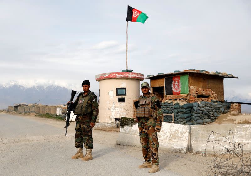 Afghan National Army (ANA) soldiers stand guard at a checkpoint outside Bagram prison, north of Kabul