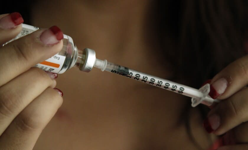 Judith Garcia, 19, fills a syringe as she prepares to give herself an injection of insulin at her home in the Los Angeles suburb of Commerce, Calif., Sunday, April 29, 2012. A major study, released Sunday, tested several ways to manage blood sugar in teens newly diagnosed with diabetes and found that nearly half of them failed within a few years and 1 in 5 suffered serious complications. Garcia still struggles to manage her diabetes with metformin and insulin years after taking part in the study at Children's Hospital Los Angeles. (AP Photo/Reed Saxon)