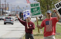 Bob Pevec, right, a 20-year GM employee, pickets outside the General Motors Fabrication Division, Monday, Sept. 23, 2019, in Parma, Ohio. Pevec is a tool and die maker. The strike against General Motors by 49,000 United Auto Workers entered its second week Monday with progress reported in negotiations but no clear end in sight. (AP Photo/Tony Dejak)