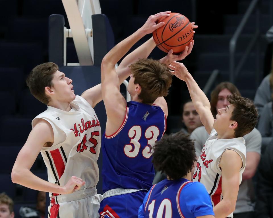 Hiland forward Alex Yoder, left, and guard Carson Habeger, right, attempt to block the shot of Crestview forward Wren Sheets during the first half of a Division IV state semifinal basketball game at UD Arena, Friday, March 17, 2023, in Dayton, Ohio.