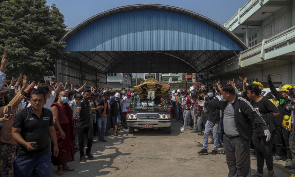 Bystanders flash a three-fingered sign of resistance as the body of Kyal Sin, also known by her Chinese name Deng Jia Xi, is driven in Mandalay, Myanmar, Thursday, 4 March 2021. Kyal Sin was shot in the head by Myanmar security forces during an anti-coup protest rally she was attending Wednesday.