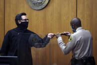 Los Angeles Superior Court Judge Mark E. Windham receives the verdict from the bailiff during the Robert Durst murder trial Friday, Sept. 17, 2021 in Inglewood, Calif. A Los Angeles jury convicted Robert Durst on Friday of murdering his best friend 20 years ago, a case that took on new life after the New York real estate heir participated in a documentary that connected him to the slaying that was linked to his wife’s 1982 disappearance. (Genaro Molina/Los Angeles Times via AP, Pool)