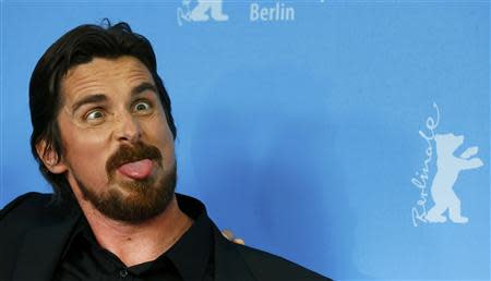 Actor Christian Bale poses to promote the movie American Hustle at the 64th Berlinale International Film Festival in Berlin February 7, 2014. REUTERS/Tobias Schwarz