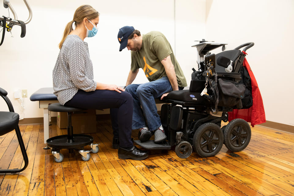 Dawn Hamline, clinical educator, watches as Derek O'Brien, an iBOT personal mobility device user, gets into his iBOT at Mobius Mobility headquarters, on May 4, 2021, in Manchester, New Hampshire. (Kayana Szymczak for Yahoo News)




