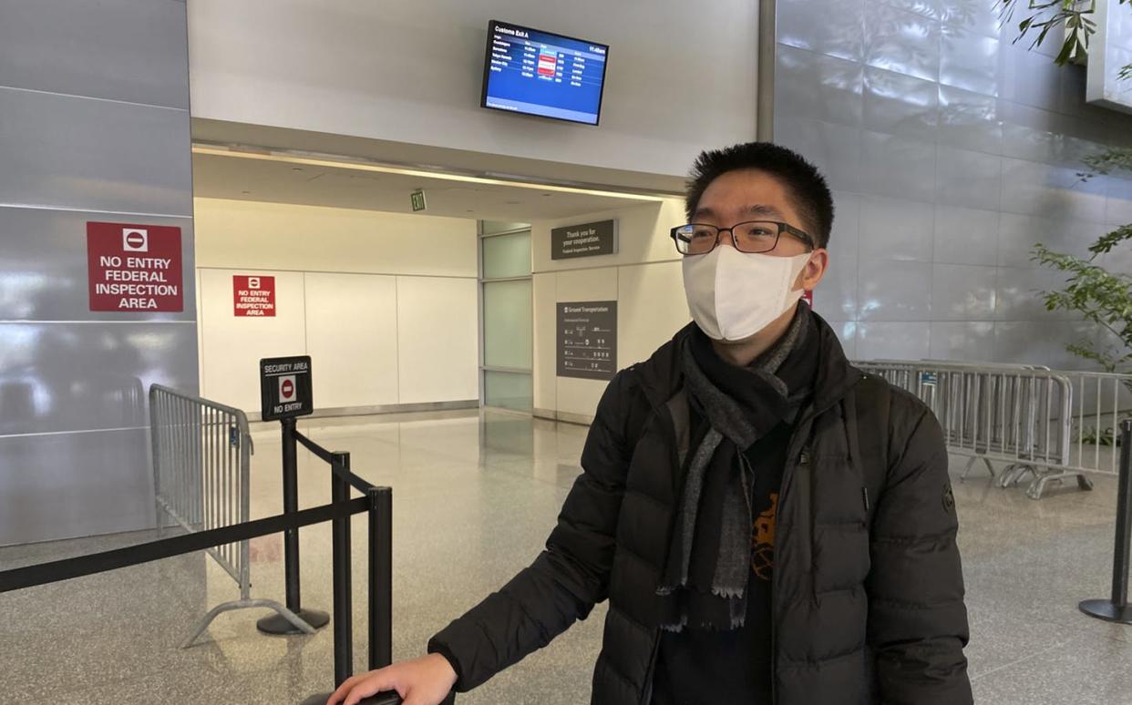 <span class="caption">Bill Chen at San Francisco International Airport after arriving on a flight from Shanghai. Chen said his temperature was screened at the Shanghai airport before he departed. </span> <span class="attribution"><a class="link " href="http://www.apimages.com/metadata/Index/China-Outbreak-Flying/1a46c5b4a0aa41158a3ea2483c55b913/2/0" rel="nofollow noopener" target="_blank" data-ylk="slk:AP Photo / Terry Chea;elm:context_link;itc:0;sec:content-canvas">AP Photo / Terry Chea</a></span>