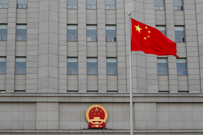 FILE PHOTO: A Chinese national flag waves outside Beijing No. 2 Intermediate People's Court where Australian writer Yang Hengjun is expected to face trial on espionage charges, in Beijing