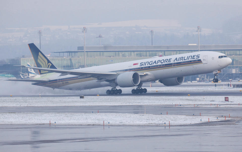 A Boeing 777-312ER aircraft of Singapore Airlines takes off during cold winter weather from Zurich Airport near Ruemlang, Switzerland, December 14, 2022.