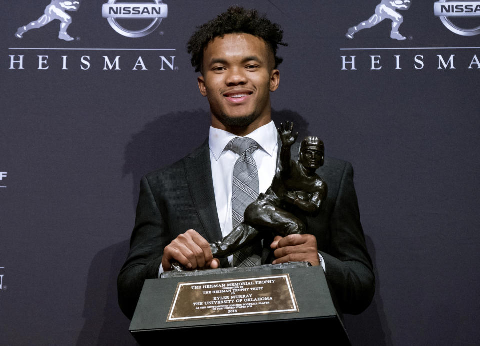 FILE - In this Dec. 8, 2018, file photo, Oklahoma quarterback Kyler Murray holds the Heisman Trophy after winning the award in New York. Murray is a prospect in the 2019 NFL Draft. (AP Photo/Craig Ruttle, File)