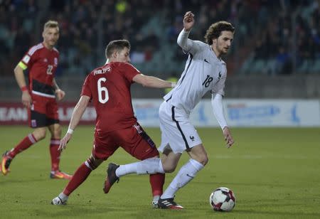 Football Soccer - Luxembourg v France - 2018 World Cup Qualifying European Zone - Group A - Josy-Barthel Stadium, Luxembourg, Luxembourg - 25/3/17 Luxembourg's Chris Philipps in action with France's Adrien Rabiot Reuters / Eric Vidal Livepic