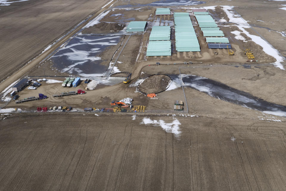 In this April 13, 2020, photo provided by TC Energy, a pipe storage yard with material for construction of the Keystone XL oil pipeline is seen at a staging area along the U.S.-Canada border north of Glasgow, Mont. U.S. District Judge Brian Morris has struck down a nationwide permitting program for new oil and gas pipelines in a lawsuit against the controversial Keystone XL oil sands pipeline from Canada. (TC Energy via AP)