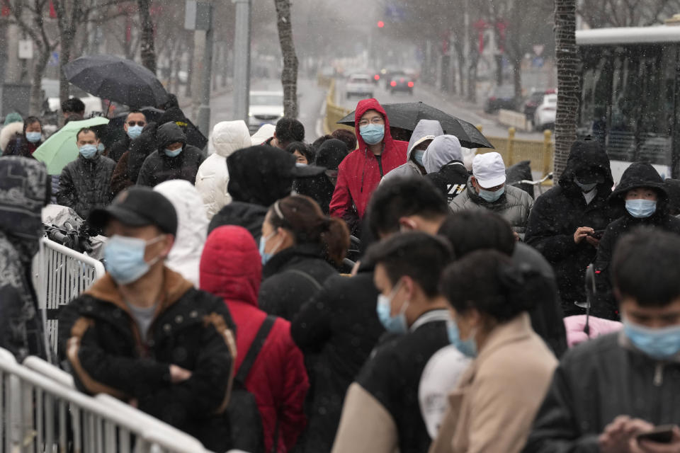 Residents line up for COVID-19 test as snow falls on Thursday, March 17, 2022, in Beijing. A fast-spreading variant known as "stealth omicron" is testing China's zero-tolerance strategy, which had kept the virus at bay since the deadly initial outbreak in the city of Wuhan in early 2020. (AP Photo/Ng Han Guan)