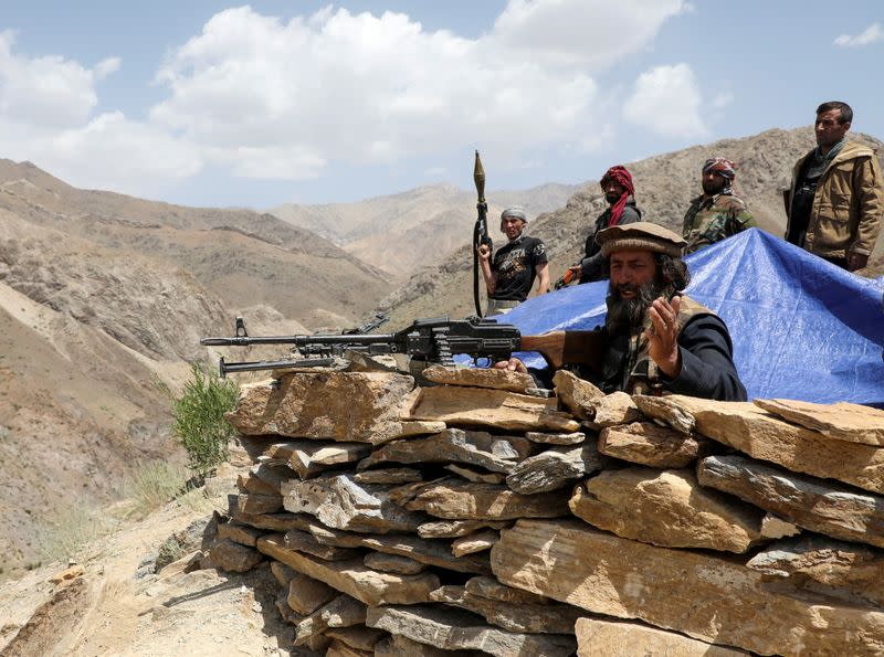 FILE PHOTO: Armed men who are against Taliban uprising stand at their check post, at the Ghorband District