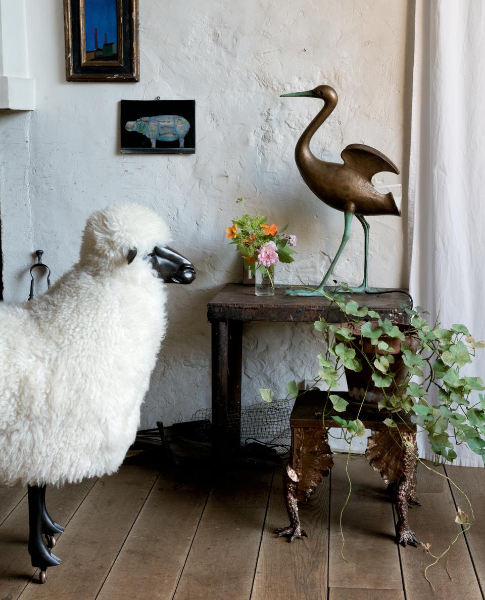 Objects by François-Xavier (sheep, bird, and painting) mix with design by Claude (stool) at the late couple's home.