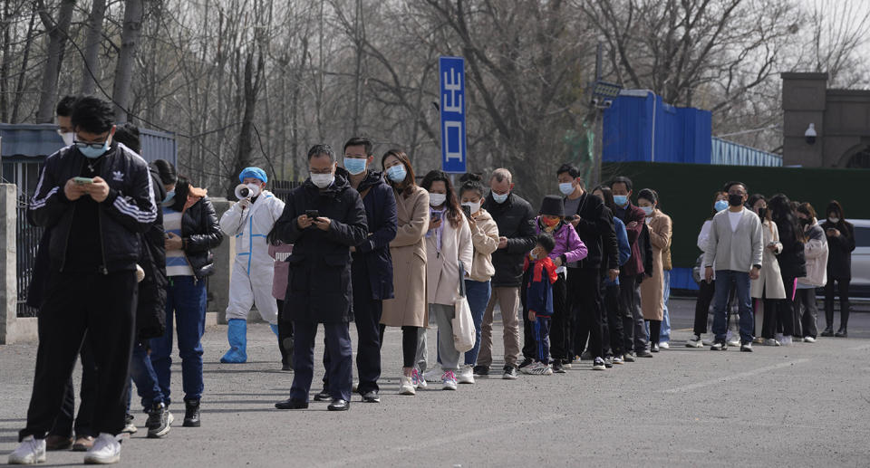 People in Beijing, China, line up at coronavirus testing site after the country faces the biggest spike in cases since the pandemic began. 