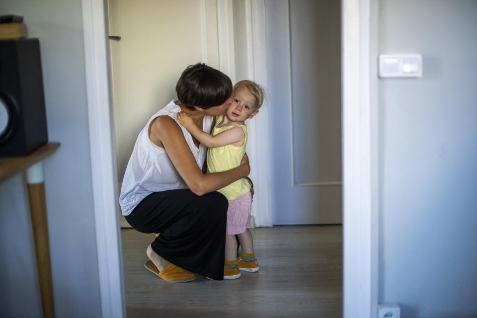 In this photo taken on Wednesday, June 19, 2019, Clara Massons kisses her two years old son Jaume at her home in Barcelona, Spain. Outdated medical practices related to childbirth that continue to be used despite evidence they cause harm have come under increasing scrutiny in Europe. (AP Photo/Emilio Morenatti)