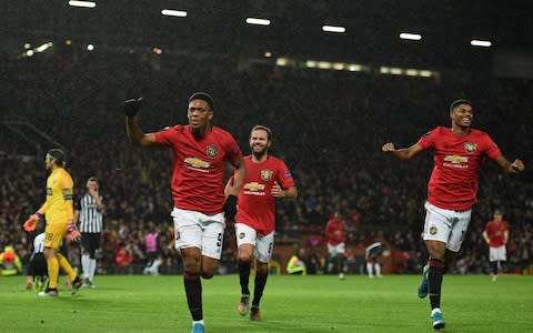 Manchester United's French striker Anthony Martial (2nd L) runs to celebrate scoring their second goal during the UEFA Europa League Group L football match between Manchester United and Partizan Belgrade  - Credit: AFP