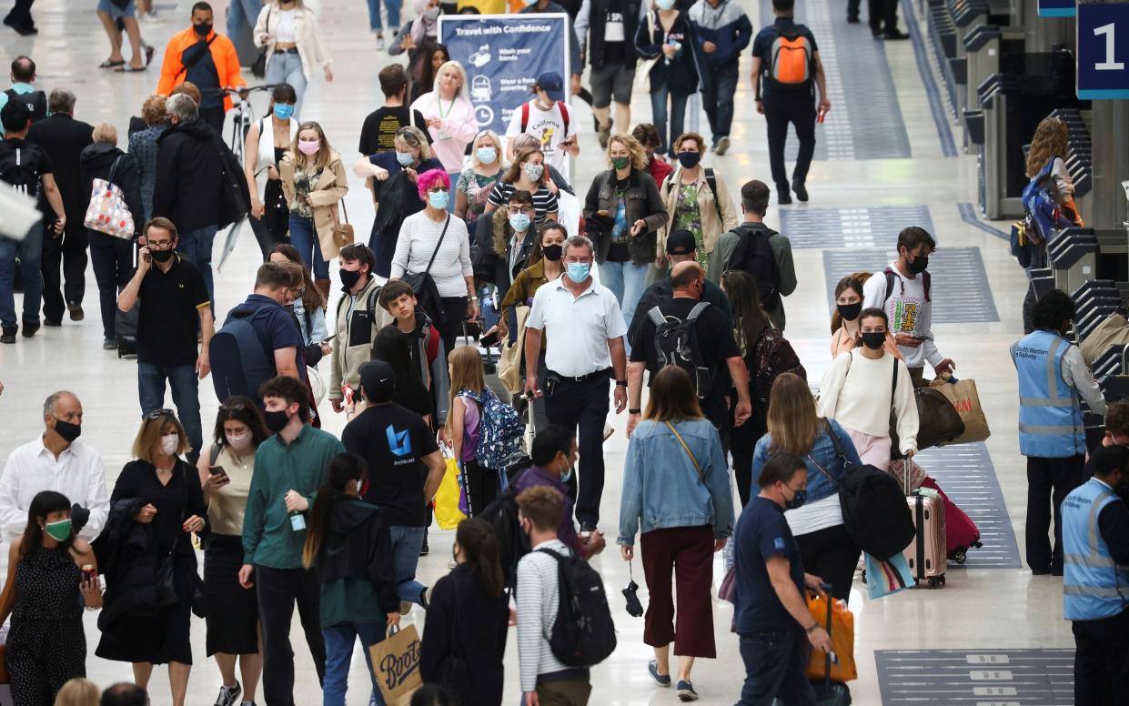 People wearing face masks in Waterloo station - Henry Nicholls/Reuters