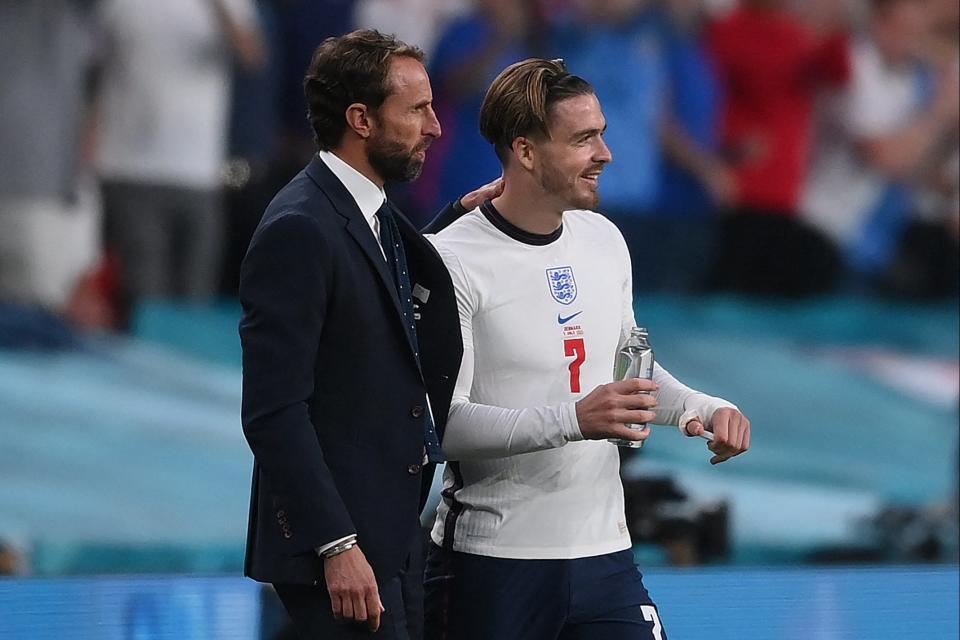 Gareth Southgate speaks with  Jack Grealish before being substituted (POOL/AFP via Getty Images)