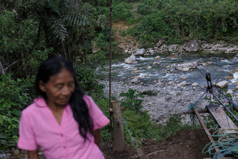 Mónica Tanguila, wife of Clemente Grefa, on the banks near a cable car connecting communities on opposite sides of the river.<span class="copyright">Andrés Yépez for TIME</span>