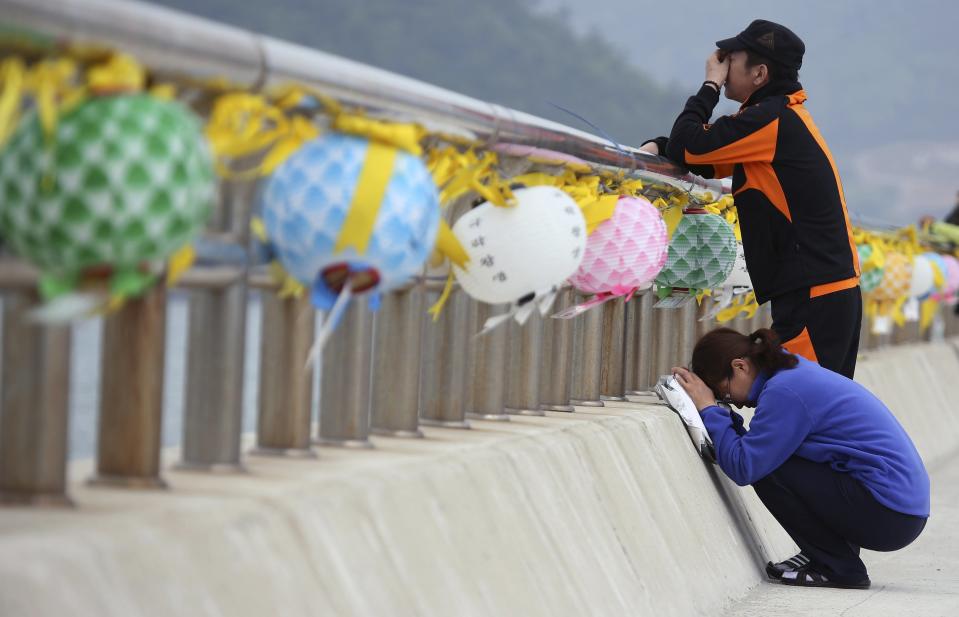 Family members of missing passengers onboard the sunken Sewol passenger ferry cry at a port where family members of missing passengers have gathered in Jindo May 8, 2014. South Korean prosecutors are seeking the arrest of members of the family that owns the operator of the ferry that sank last month killing hundreds of school children, an avoidable tragedy that rocked the country to the core. REUTERS/Yonhap (SOUTH KOREA - Tags: DISASTER MARITIME) ATTENTION EDITORS - THIS IMAGE HAS BEEN SUPPLIED BY A THIRD PARTY. NO SALES. NO ARCHIVES. FOR EDITORIAL USE ONLY. NOT FOR SALE FOR MARKETING OR ADVERTISING CAMPAIGNS. SOUTH KOREA OUT. NO COMMERCIAL OR EDITORIAL SALES IN SOUTH KOREA. THIS PICTURE IS DISTRIBUTED EXACTLY AS RECEIVED BY REUTERS, AS A SERVICE TO CLIENTS