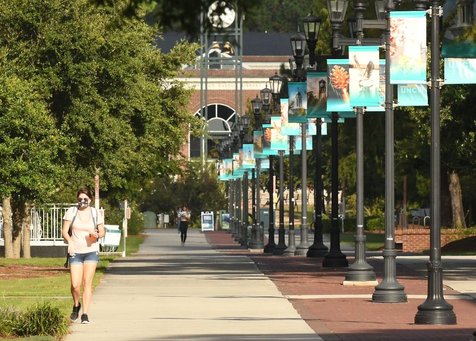 Students and faculty walk across the UNCW campus in September 2020. Nearly one in three North Carolina college students will qualify for loan forgiveness after President Joe Biden announced his plan Wednesday.