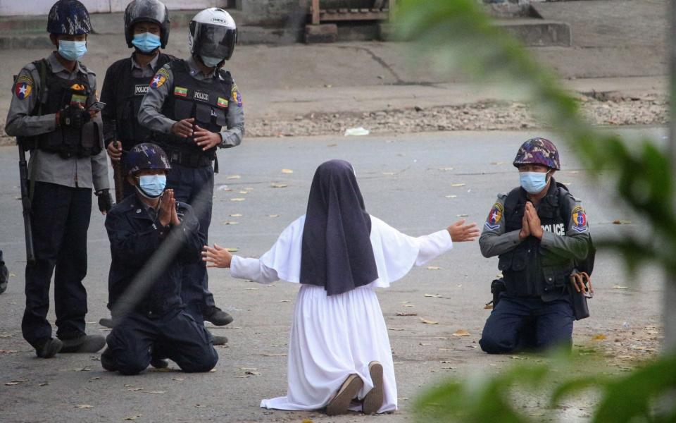 A nun pleading with police not to harm protesters in Myitkyina, March 2021 - AFP