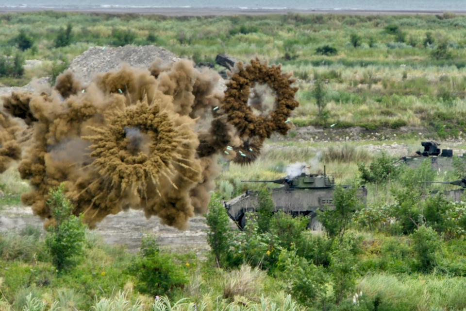 Image: Two domestically-made armoured vehicles launch smoke grenades during the annual Han Kuang military drills in Taichung, Taiwan (Sam Yeh / AFP - Getty Images)