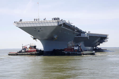 FILE PHOTO: Pre-Commissioning Unit Gerald R. Ford (CVN 78) is maneuvered by tug boats in the James River during the aircraft carrier's turn ship evolution in Newport News, Virginia, U.S. June 11, 2016. U.S. Navy/Mass Communication Specialist Seaman Apprentice Gitte Schirrmacher/Handout via REUTERS/File Photo